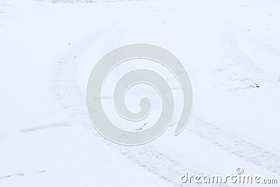 Wintertime road covered with snow with traces of car tires prints. White bacground. Winter day. Be careful Stock Photo