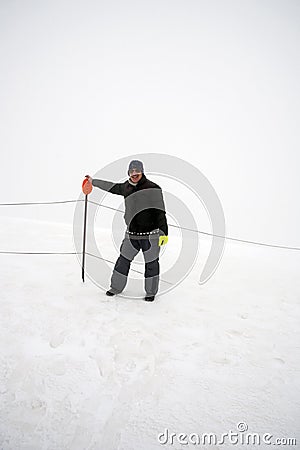 Wintertime: time to have fun in a ski resort. Snow, mountaintop, haziness, skiing. Stock Photo