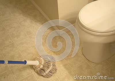 Wiped the bathroom tiled floor with mop Stock Photo