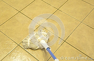 Wiped tiled floor with mop Stock Photo