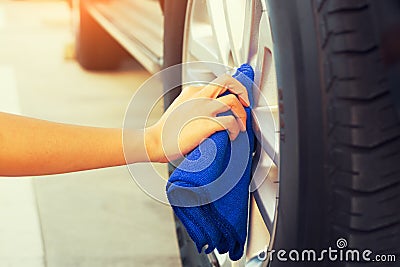 Wiping alloy wheels Stock Photo