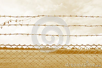 Barbed wire imprison, detention center, incarcerate, Barbed wire detention center at countryside and background sepia color style Stock Photo