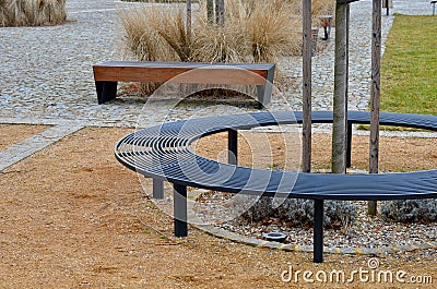 wire circular benches park furniture in winter. sintered gravel with Stock Photo