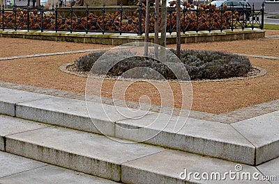 wire circular benches park furniture in winter. sintered gravel with Stock Photo