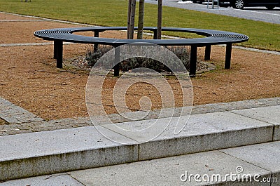 wire circular benches park furniture in winter. sintered gravel Stock Photo