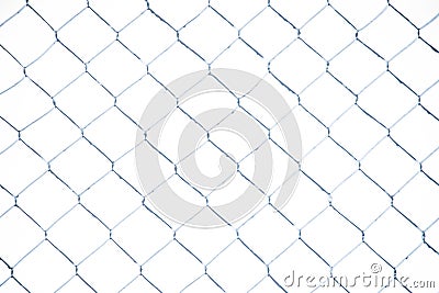 Wire fence in the snow. Fence background. Metallic net with snow. Metal net in winter covered with snow. Wire fence closeup. Steel Stock Photo