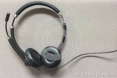 Wire Headset at Corner on Gray Textile Background Stock Photo