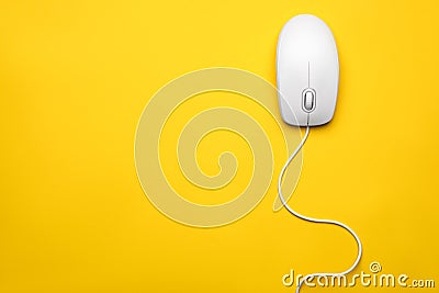 Wired computer mouse on yellow background. Space for text Stock Photo