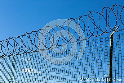 Wired Fence with Spiral Barbwire Stock Photo