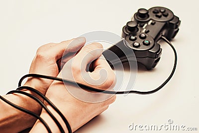 Wired hands with joypad close up meaning videogame addiction Stock Photo