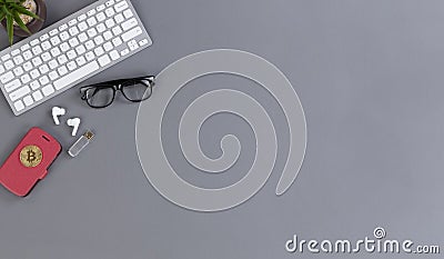 Wireless working desktop with smartphone, bitcoin, computer keyboard, thumb drive, baby plant and reading glasses Stock Photo