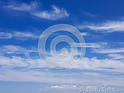 Wispy cirrus clouds in a blue sky Stock Photo