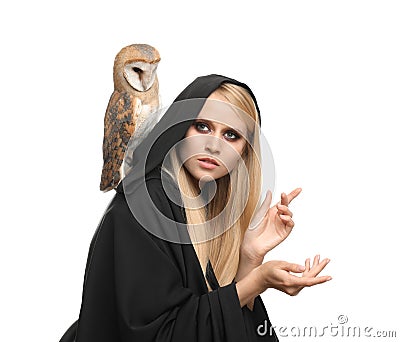 Witch in black mantle with owl isolated on white. Scary fantasy character Stock Photo