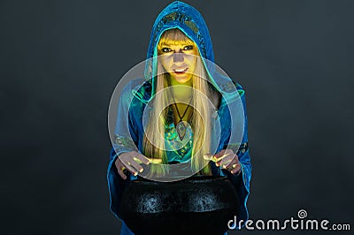 Witch with cauldron Stock Photo