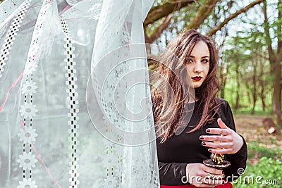 Witch in the forest with a candle Stock Photo