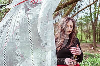 Witch in the forest with a candle Stock Photo