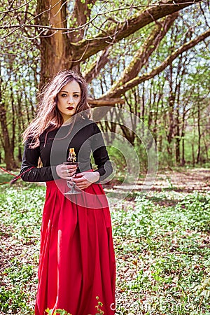 Witch in the forest with a candle Stock Photo