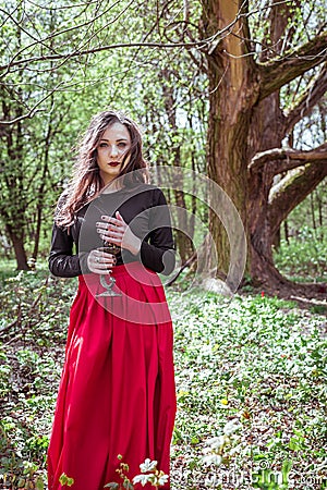 Witch in the forest with a candle Stock Photo