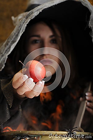 Witch giving a poisened apple Stock Photo