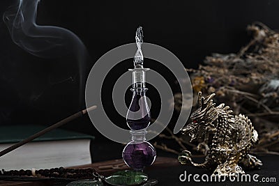 Witch kit. In the center is a purple shaped bottle with a potion. Stock Photo