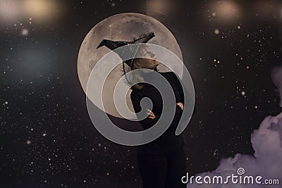 Witch, moon and clouds at night Stock Photo