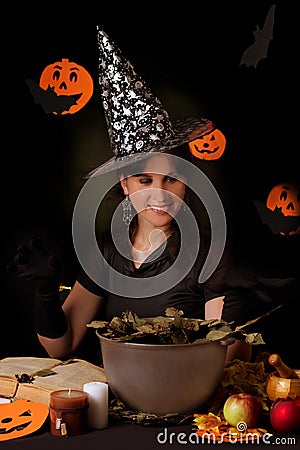 Witch practicing sorcery at Halloween night Stock Photo