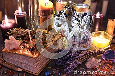Witch ritual collection with old spelling book, lavender, bottles, herbs and magic objects Stock Photo
