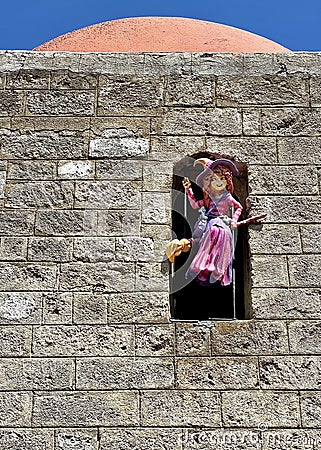 Witch in the window in the historic centre of Rhodes town. Editorial Stock Photo