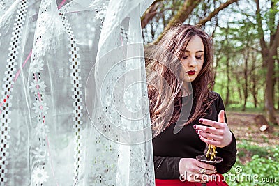 Witch in the woods with a candle Stock Photo