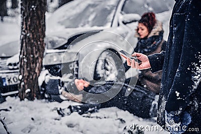 The witness of the accident keeps the phone and is going to call the rescue service. Stock Photo