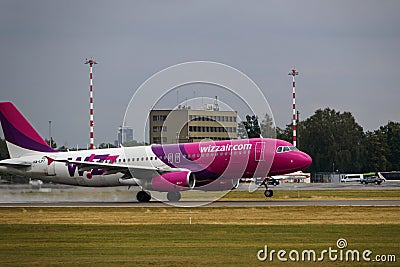 A Wizzair airliner takes off from the runway. Departure of the plane from the airport. Riga International Airport, Marupe, Latvia Editorial Stock Photo