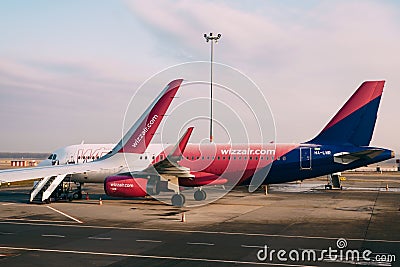 Wizzair plane on a takeoff strip at the airport Editorial Stock Photo