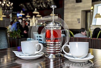 A wo cups of tea and delicious berry tea from fresh berries, for a pleasant evening rest of two friends, the interior of the resta Stock Photo