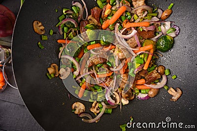 Wok, close-up, shredding meat with vegetables.Tasty food, culinary background, gastronomy Stock Photo