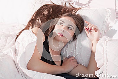 Woken up uptight woman in bed portrait Stock Photo