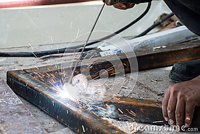 Woker welding steel with sparks lighting Stock Photo