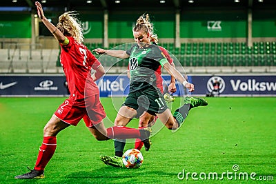 Alexandra Popp of VfL Wolfsburg against two opponents during UWCL soccer match Editorial Stock Photo