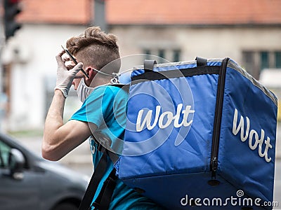 Wolt delivery man wearing a face mask protective respirator in belgrade during the Coronavirus Covid 19 crisis Editorial Stock Photo