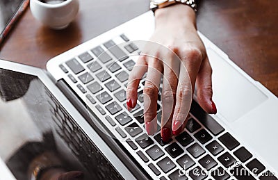 woma hand on a laptop keyboard, female hand on laptop , human hand, gadget Stock Photo