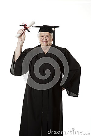 Beauitiful Caucasian woman in a black graduation gown with diploma Stock Photo