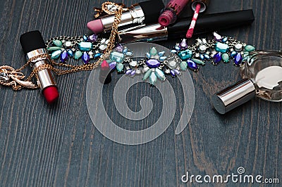 Woman accessories. Make up pieces, jewelry and shiny purse. Top view. Stock Photo