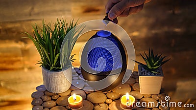 Woman adding essential oil to electric diffuser lamp, Aromatherapy Stock Photo