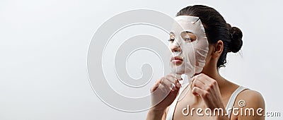 Woman adjusting facial sheet mask Stock Photo