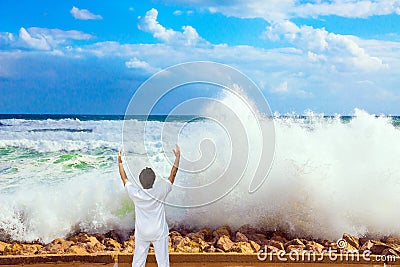 Woman admired by the power of the sea Stock Photo