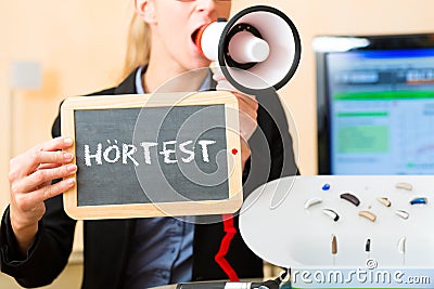 Woman advertising a hearing test Stock Photo