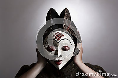 Woman with African mask Stock Photo