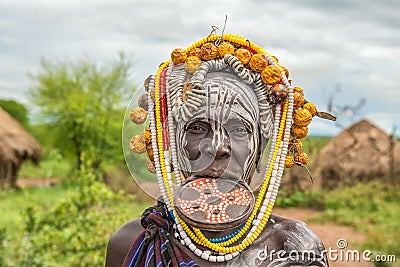 Woman from the african tribe Mursi in her village Editorial Stock Photo