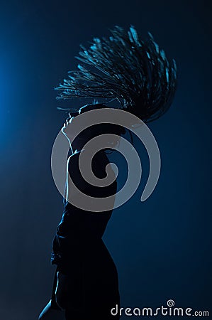 Woman afro pigtails raincoat dance floor lights Stock Photo