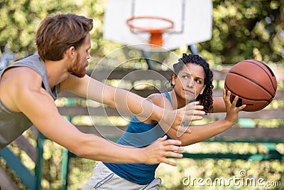 woman against man couple playing basketball Stock Photo