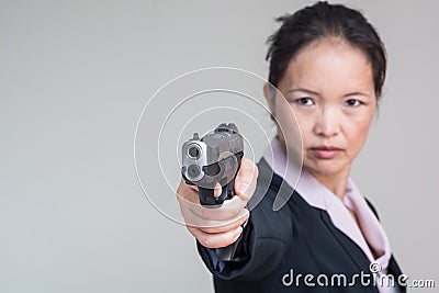 Woman aiming a hand gun Stock Photo